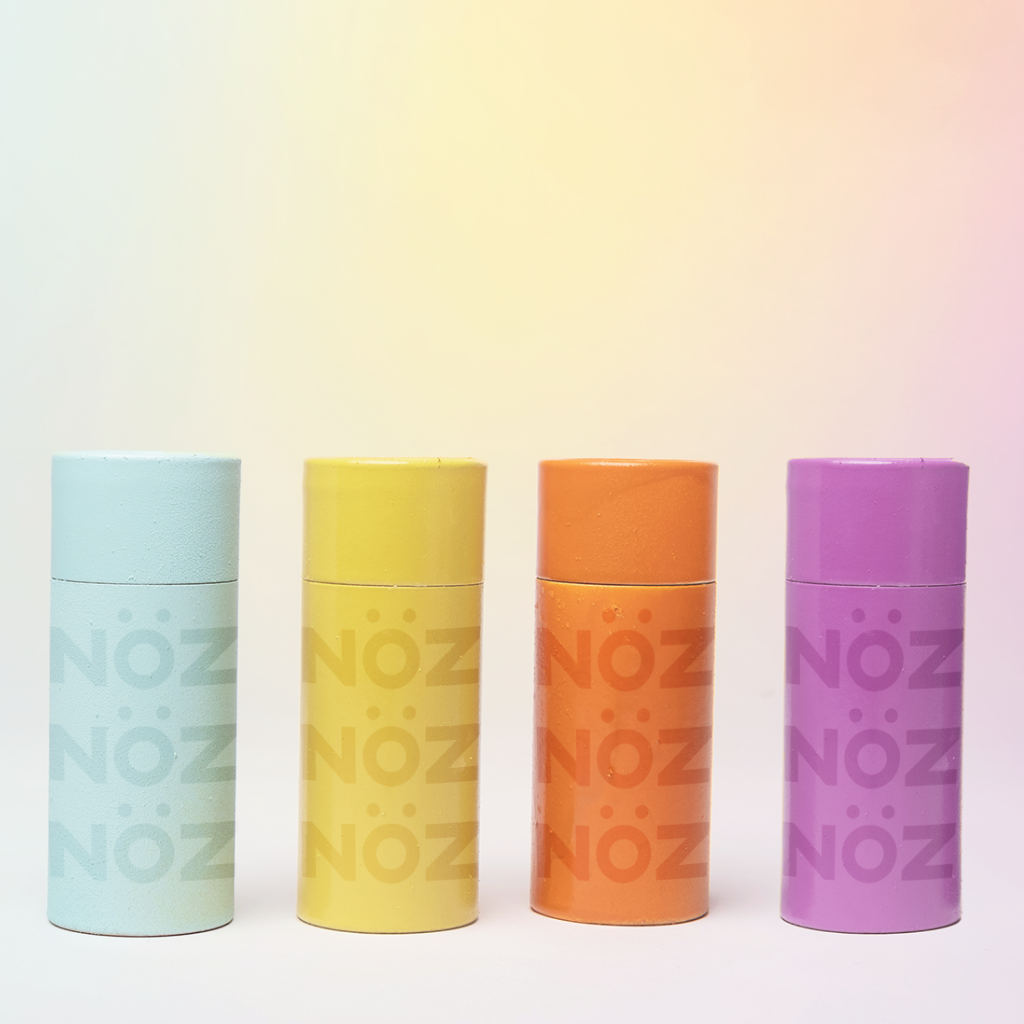 Blue, yellow, orange, and purple bottles from vegan Noz sunscreen